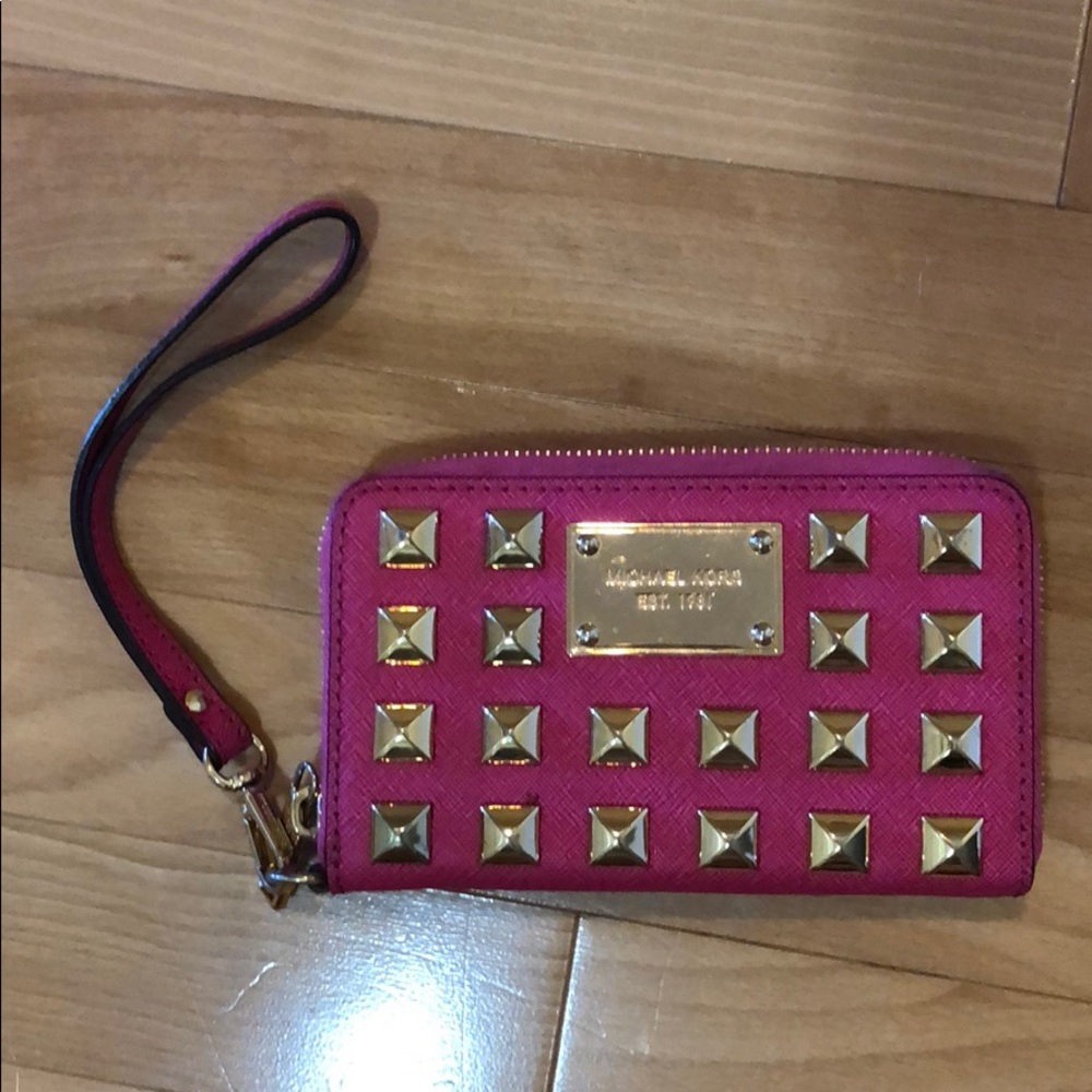 Gently used pink/gold stud Michael Kors wristlet.